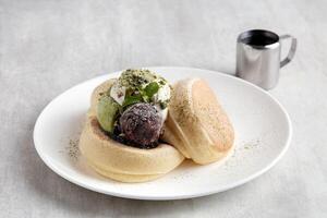 Kiseki Pancake with Matcha and Azuki Bean Paste in white plate on grey background photo