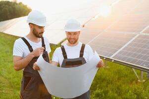 Electrical and instrument technician installation and maintenance electric system solar panel on the roof of factory,Service check installation solar cell. photo