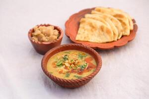 Desi breakfast, haleem, halim, dhaleem, halwa and paratha served in dish isolated on background top view of bangladesi breakfast photo