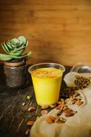 Badam sharbat, Almond milk syrup with saffron served in glass isolated on table top view of drink photo