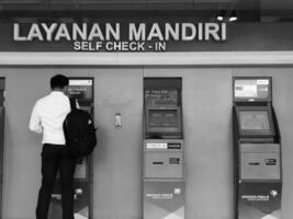 Jakarta, Indonesia on July 7 2022. Airplane passengers who are self-checking in at the machine available at Halim Perdanakusuma Airport. photo