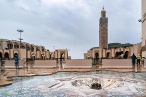 Casablanca, Morocco -march 25, 2024-People visit the famous Hassan Second Mosque during a rainy day photo