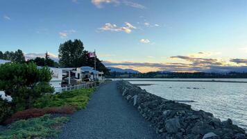 sunset on the Ocean Horizon many clouds and bright colors from the sun in the sky slow motion suitable for music relaxation background For text silence peace Parksville beach Surfside RV resort video