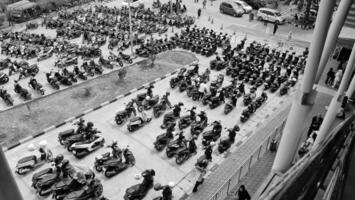 Bekasi, Indonesia on December 23 2023. Many motorized vehicles of various types fill the Bekasi Station parking lot. photo