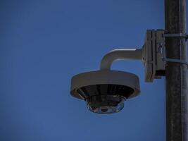 360 security camera isolated on blue sky background photo