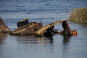 abandoned rusted bulldozer in Aveiro lagoon Ria de Aveiro located on the Atlantic coast of Portugal photo