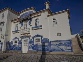 Aveiro Railway station is Historic building ornamented with many typical blue Azulejos panels of Factory Fabrica da Fonte Nova displaying regional motifs. Portugal. photo