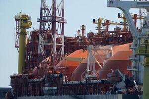 regasifier ship LNG Liquified Natural Gas tanker anchored in Genoa Harbor, Italy photo