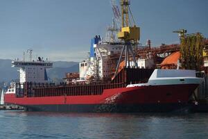 regasifier ship LNG Liquified Natural Gas tanker anchored in Genoa Harbor, Italy photo