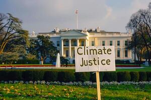 Climate Justice text on a banner outside the white house in washington dc photo