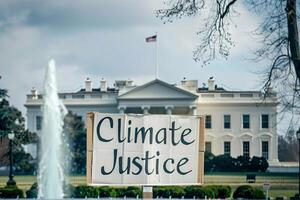 Climate Justice text on a banner outside the white house in washington dc photo