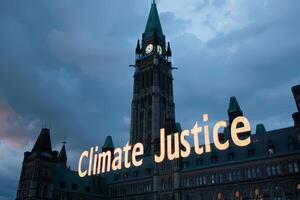 Climate Justice text on a banner outside the parliament photo