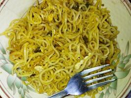 a plate with noodles and a fork photo