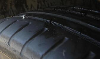 Metal Screw In Vehicle Tire Closeup photo