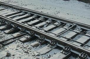 Railway track under snow cover angle view stock photo