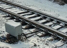 Track switch box near spare railway track at winter photo