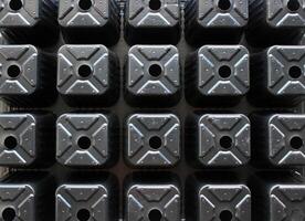 Abstract Pattern Of Black Plastic Seed Tray With Empty Cells Texture Background photo