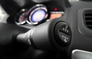 Wiper shift lever macro shot with dashboard in soft focus inside the car photo