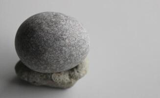 Single Zen Stone On White Surface At A Side Of Image Stock Photo For Backgrounds