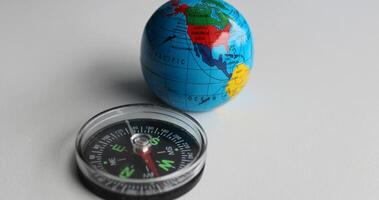 Vintage Compass And Earth Sphere Lying On White Surface Studio Isolated photo