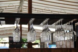 Crystal glasses upside down in the open air bar stock photo