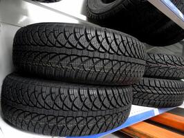 Studless winter tire on the shelf at car parts store photo