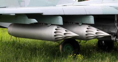 Rocket launcher system under the wing of military fighter photo