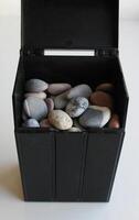 Front View Of Black Box With Decorative Stones For Decoration And Landscaping photo