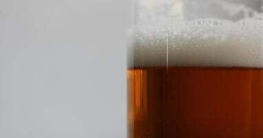 Foam On Brown Strong Beer In A Beer Glass Extreme Closeup Stock Photo