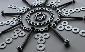 Shiny Steel Nuts, Washers And Variety Bolts Arranged With Symbolic Star Shape photo