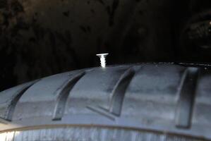 Screw Sticks Out Of Vehicle Tire photo