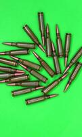 Scattered Bullets On A Green Chroma Key Isolated Vertical Background photo