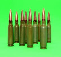 Ammunition bullets lined up with groups on a green screen background isolated stock photo