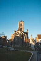 Belfry of Ghent during sunrise in the city centre. Historical landmark. The landmark of the city of Ghent in the west of the country photo