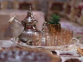 Traditional Moroccan tea set displayed elegantly on a silver tray photo