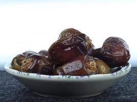 A Small Serving of Dates Arranged Elegantly on a Plate photo