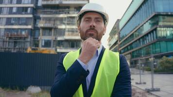 Caucasian pensive adult man heavy metal building industry worker inspector thinking architect looking at skyscrapers contractor think engineer in hardhat thoughtful dissatisfied frustrated problem video