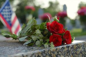 D-Day Anniversary. Hybrid tea roses and an American flag adorn a grave in a solemn landscape photo