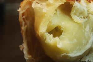 macrophotography of the insides of a bread filled with cheese photo