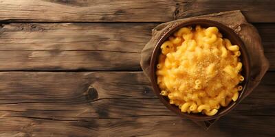 a bowl of macaroni and cheese on a wooden table photo