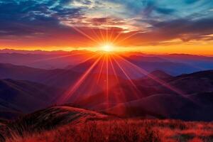 The sky glows orange and red at sunset over the mountains photo