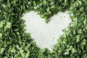 Fresh dried greenery parsley in shape of heart adaptogens ingredient. Herbal medicine healthy eating. Superfood prebiotic food. Sustainable homegrown organic herbs photo