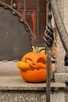 Halloween decorated outdoor cafe or restaurant terrace in America or Europe with carved pumpkins traditional attributes of Halloween. Frontyard decoration for party. photo