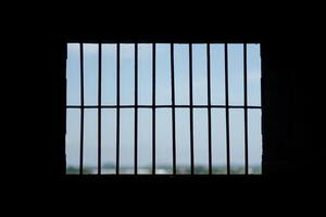 The prisons iron bars with a refreshing view beyond photo