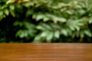 Selective Focus and Blur on Wooden Table with Green Leaves as Commercial Background photo