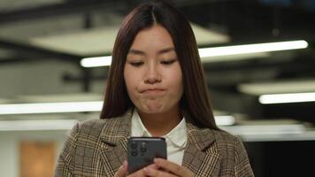 Sad frustrated frown failure stressed upset Asian woman business worker user Japanese student girl looking mobile phone bad news problem lost smartphone Korean businesswoman Chinese female in office video