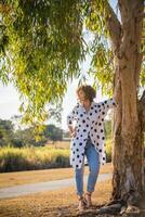 Fashion shot of a beautiful boho style girl on nature background. Boho, hippie. photo