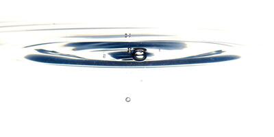 The round transparent drop of water, falls downwards photo