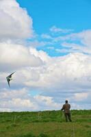 A Man flying his kite at the steppe photo