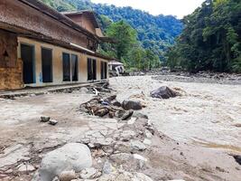 Tanah Datar, Indonesia - May 12, 2024. The back of a building affected by cold lava flash floods, a natural disaster in Lembah Anai, Sepuluh Koto District, Tanah Datar Regency, West Sumatra, Indonesia photo